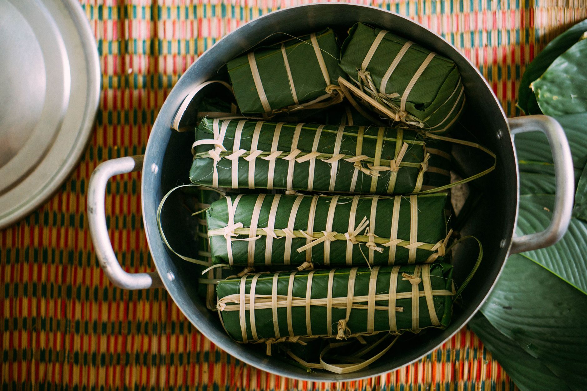 Authentic Khmer cakes wrapped in leaves, showcasing traditional Cambodian street food preparation.